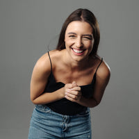 Thumbnail for Smiling woman in casual attire showcasing happiness and joy, perfect for lifestyle or fashion imagery.