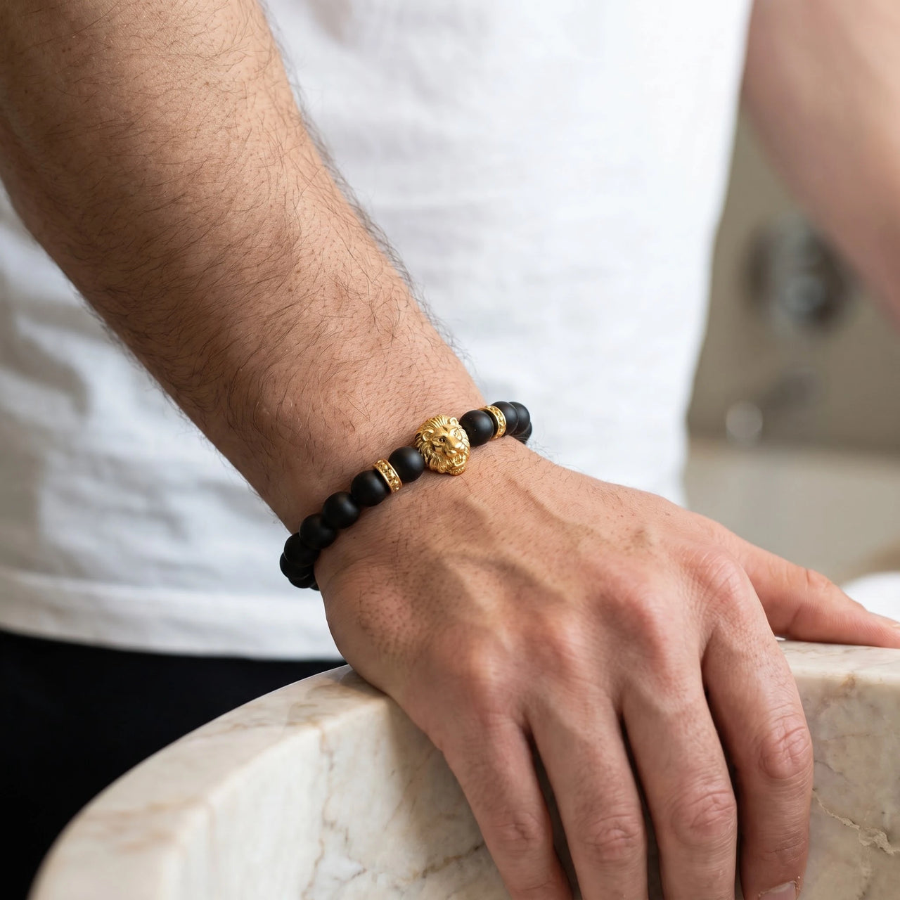 Gold Lion & Black Stones Bracelet – close-up worn on a man's wrist | Brother & Sisters | SKU: 20712286-gold-XS-14-15, 20712286-gold-S-16-17, 20712286-gold-M-18-19, 20712286-gold-L-20-21, 20712286-gold-XL-22-23