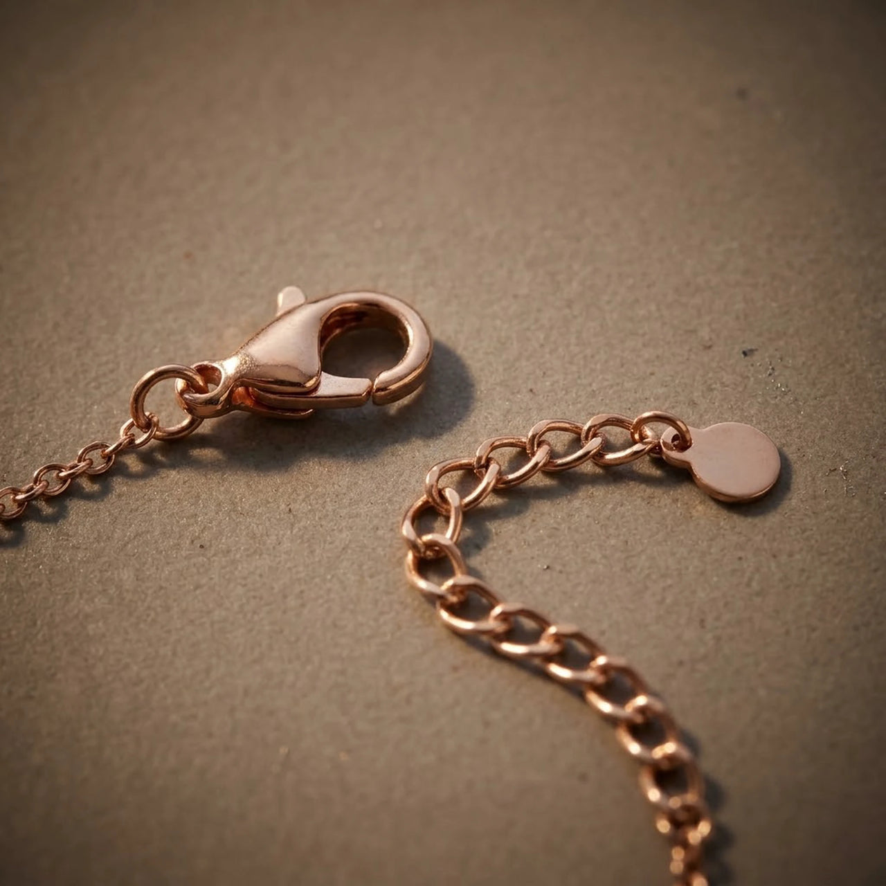 Close-up of the lobster clasp and extension chain of the rose gold Crystal Bar Bracelet