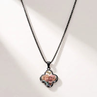 Thumbnail for Secret Clover Photo Necklace in black, four-leaf clover pendant on a box chain showing the hidden photo | SKU: TPH-CLVN-BLACK